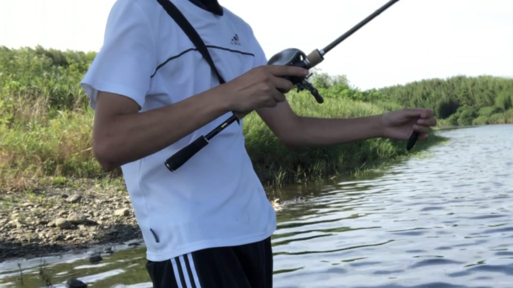 ベイトリールとルアーを手に持った写真